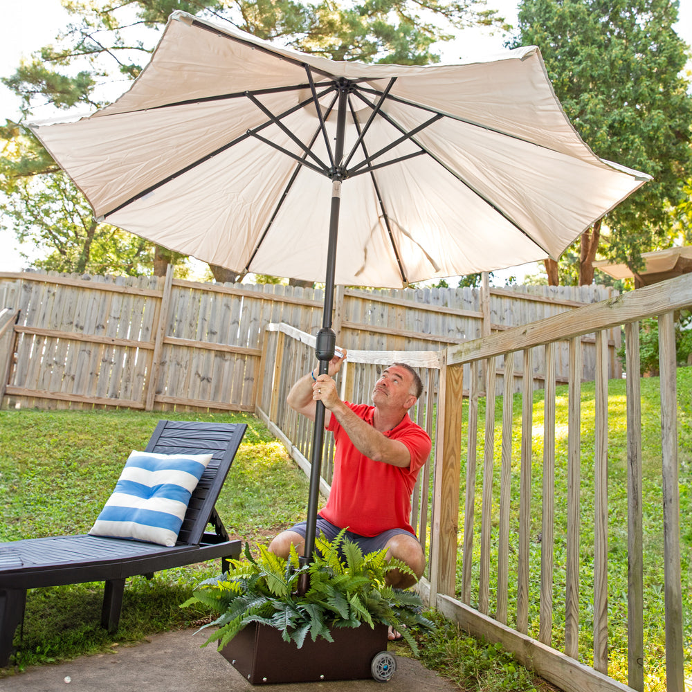 Sunnydaze Umbrella Stand Planter with Wheels Bronze with umbrella in use